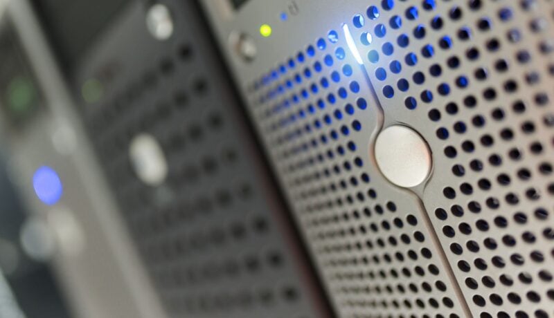 Focused detail of a modern server rack with blue LED indicators in a data center.