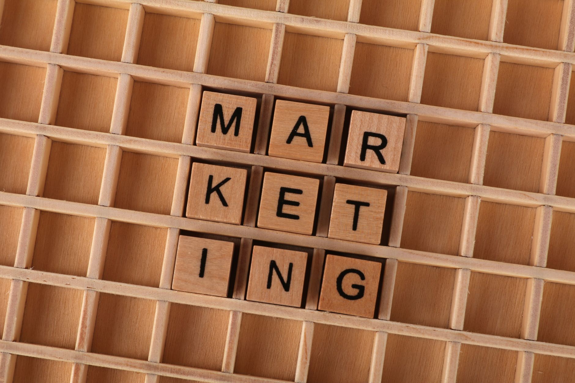 Display Advertising Best Practices: Placements, Creative, and Measurement 1 Wooden letter tiles spell out the word marketing on a grid background, showcasing creativity and business concept.