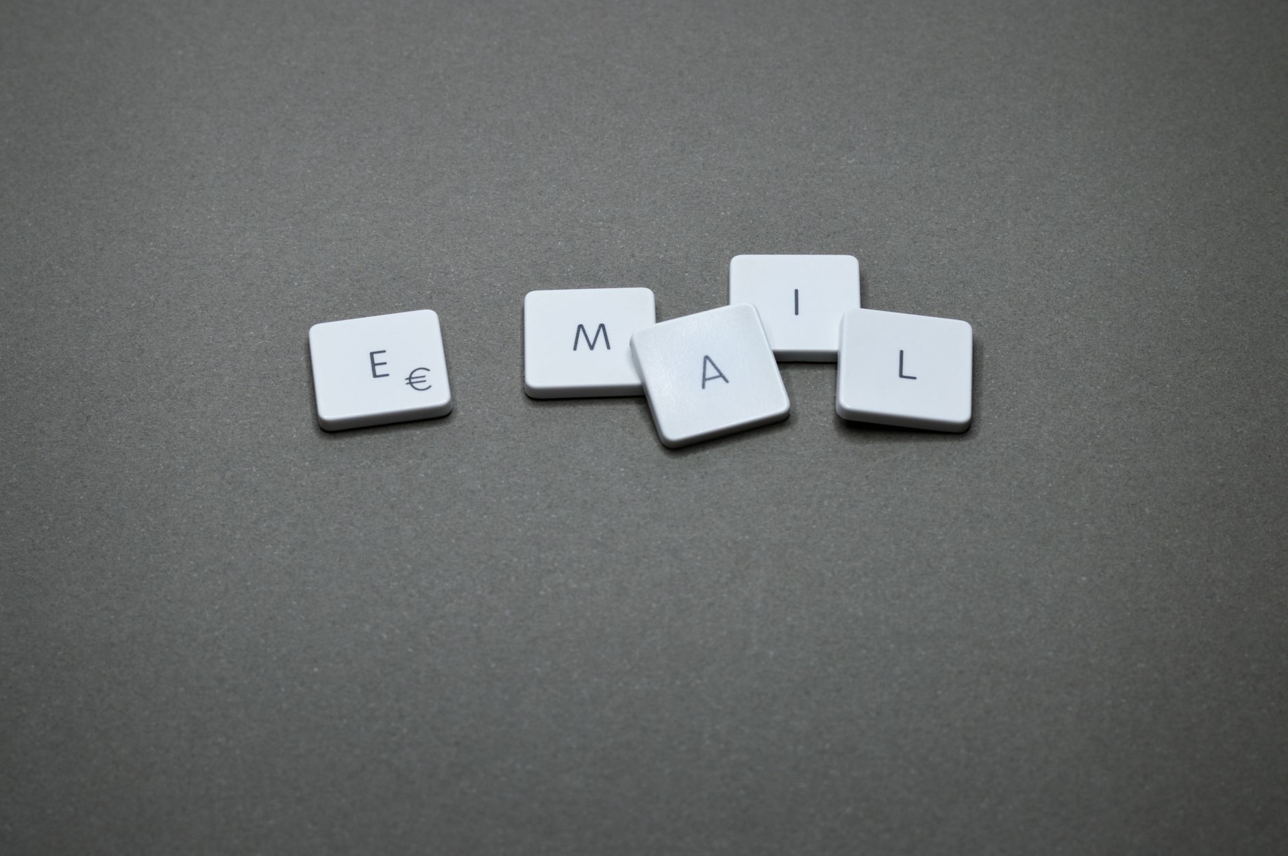 Email Marketing Automation for B2B: Workflows That Don't Feel Robotic 1 Close-up of the word 'email' formed with letter tiles on a gray surface.