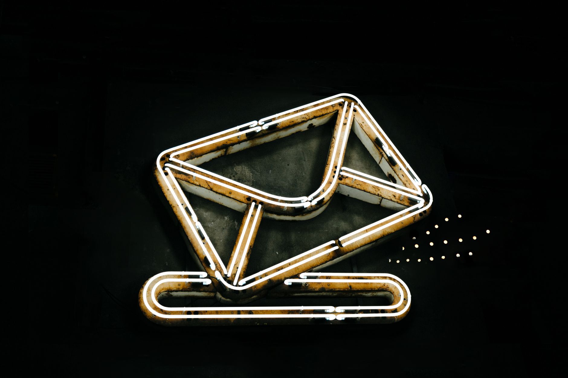 Email Nurture Sequences: Turn Captured Leads Into Sales Conversations 1 A glowing neon envelope symbol against a black background, conveying messaging or email concept.