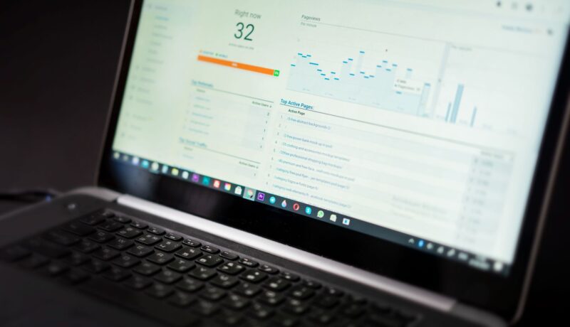 A laptop displaying an analytics dashboard with real-time data tracking and analysis tools.