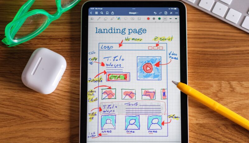 Close-up of tablet showing a hand-drawn landing page design, ideal for web development concepts.