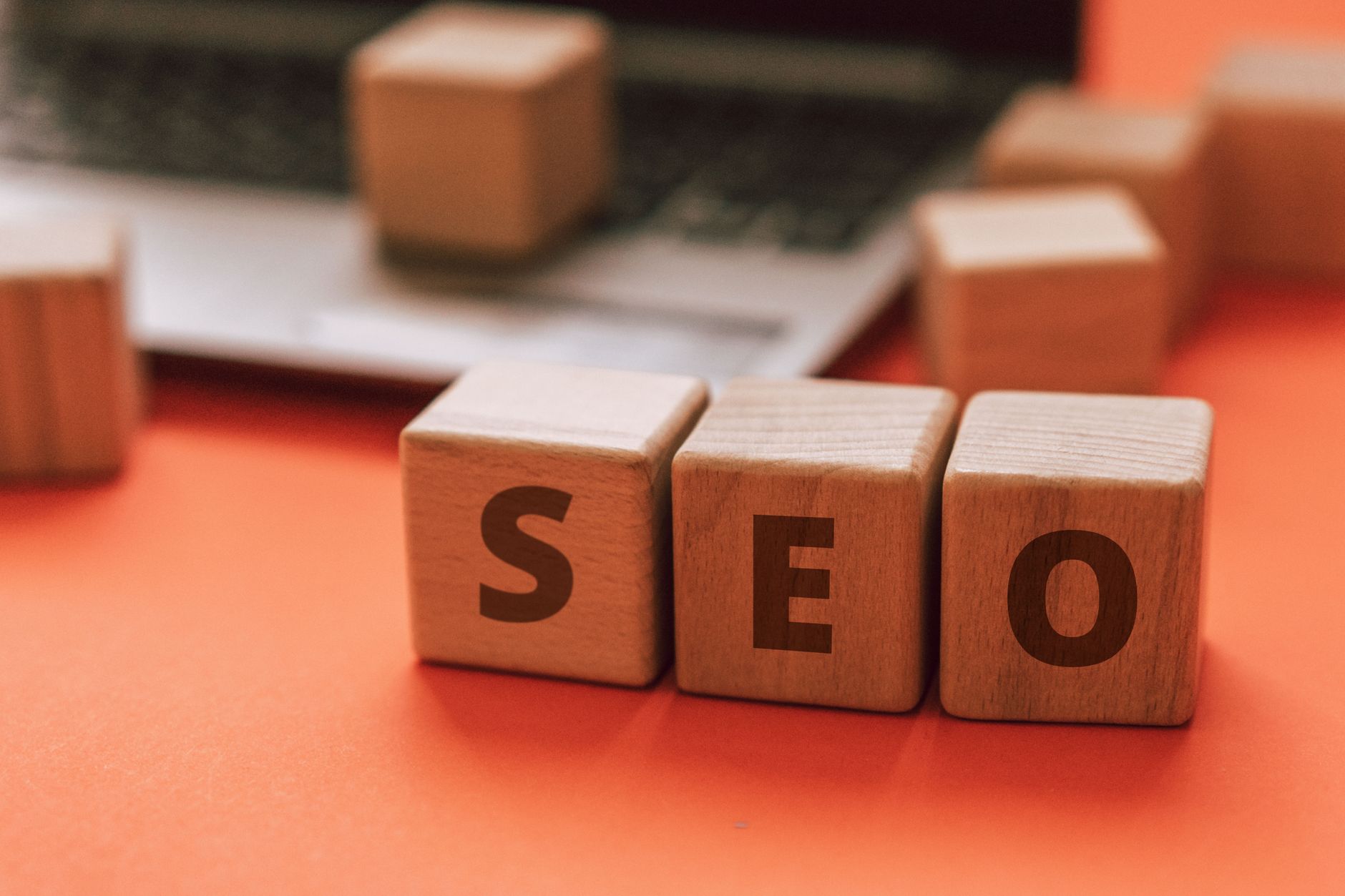 B2B SEO Strategy for Lead Generation: Intent Over Volume 1 Wooden blocks spelling SEO on a laptop keyboard convey digital marketing concepts.