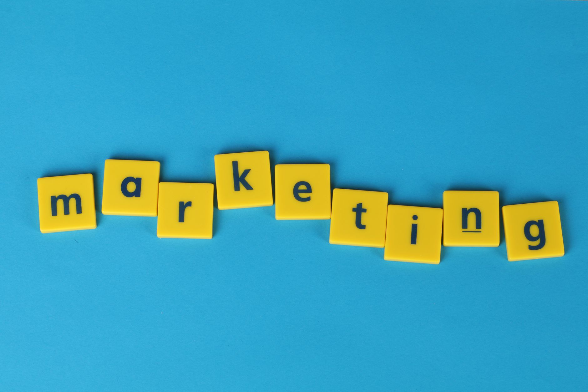 Marketing Creative Brief Template: Align Strategy Before You Design 1 Bright yellow tiles spelling 'marketing' on a blue background, ideal for business themes.