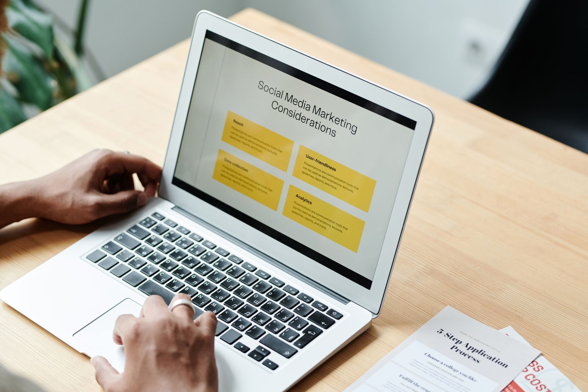 PPC Landing Page Best Practices: Message Match and One Conversion Goal 1 A person using a laptop to review social media marketing strategies at home.