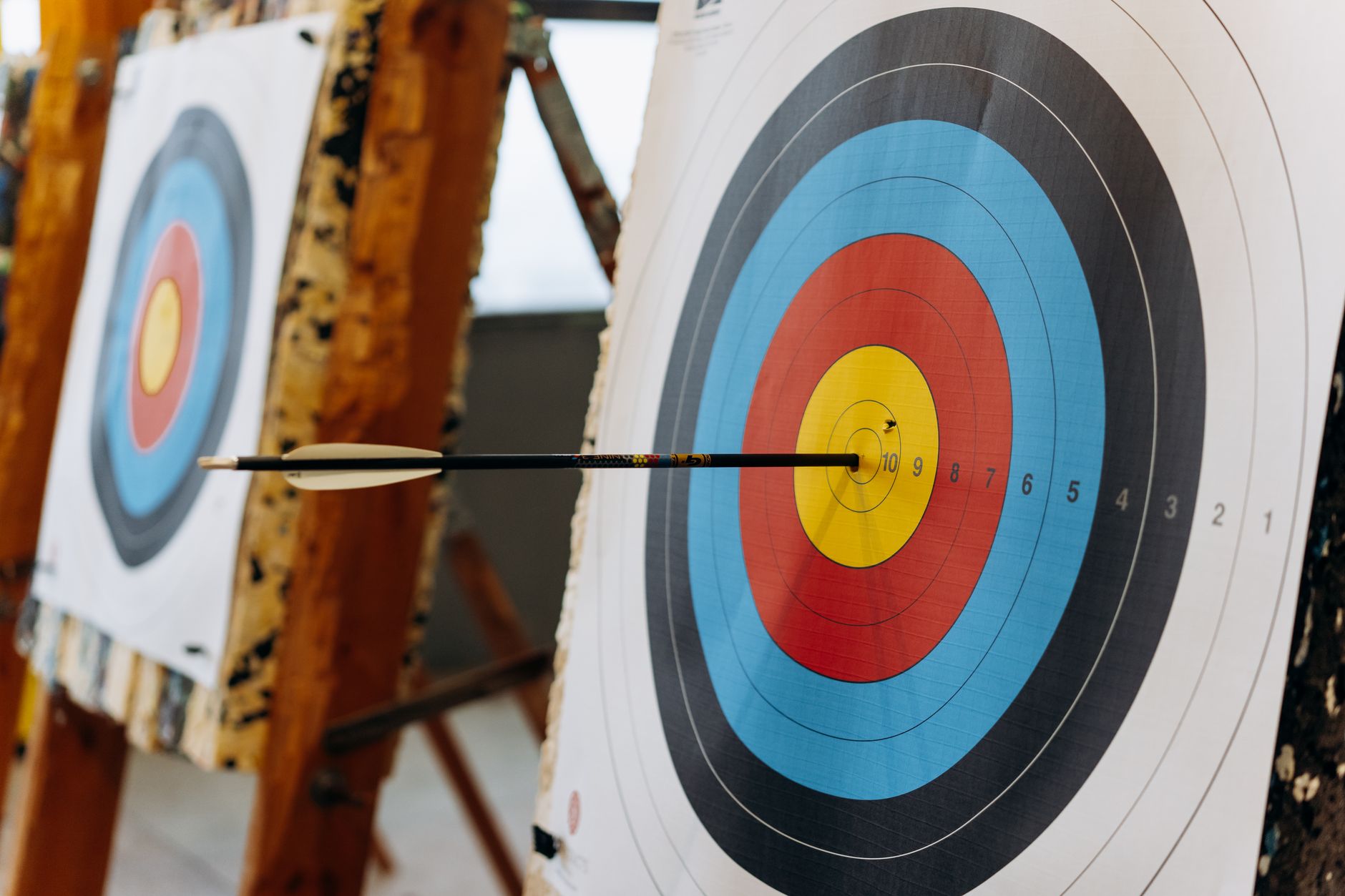 Retargeting Strategy for B2B: Bring Back Visitors Who Didn't Convert 1 An arrow hits the bullseye on a colorful target in an indoor archery range.