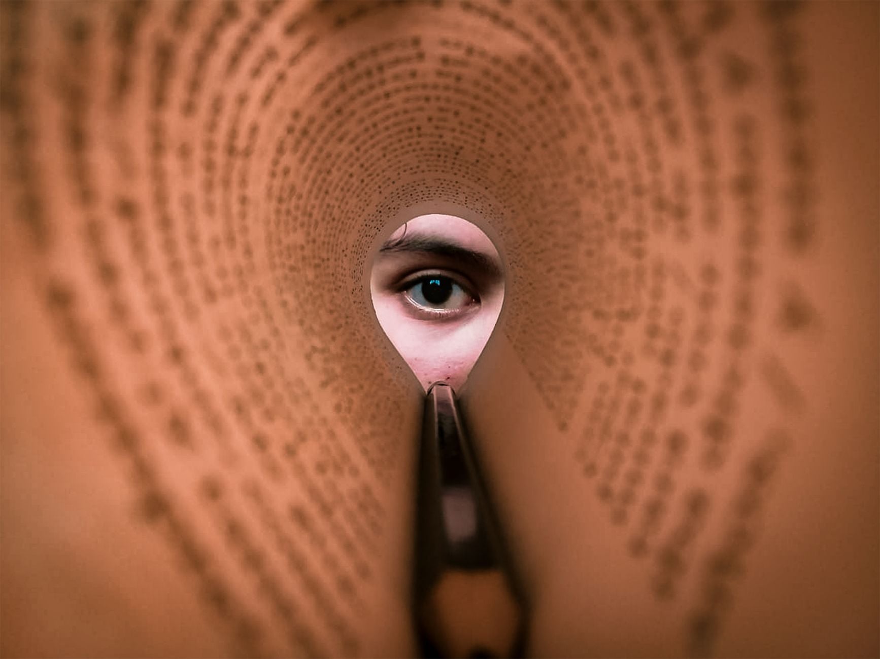 SEO Content Briefs: Give Writers Intent, Not Just Keywords 1 A person's eye looking through a rolled book page, creating a unique viewpoint.