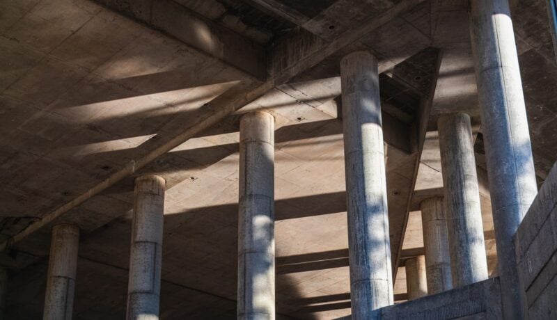 Sunlit concrete structure with strong architectural lines and shadows.