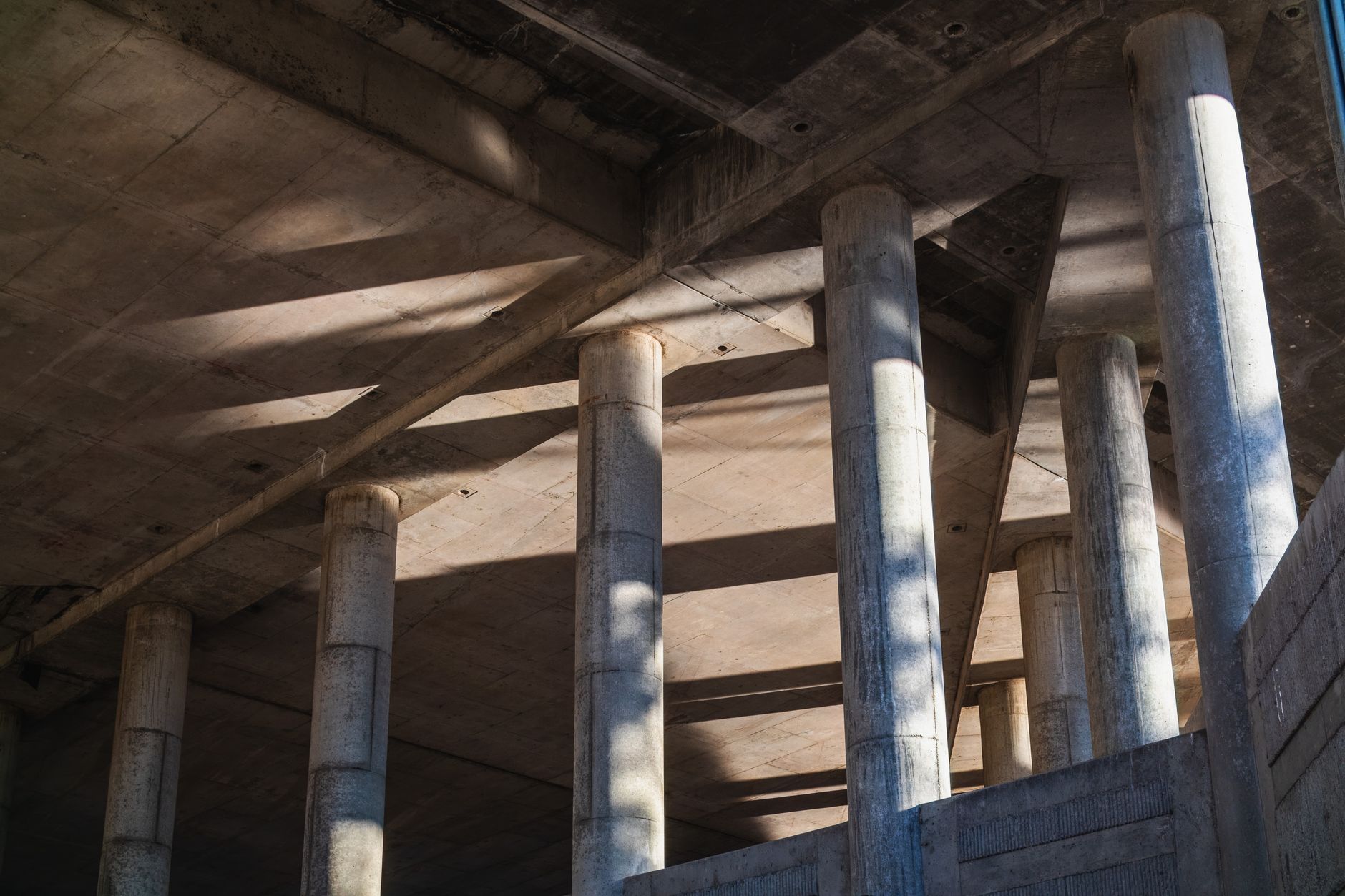 Sunlit concrete structure with strong architectural lines and shadows.