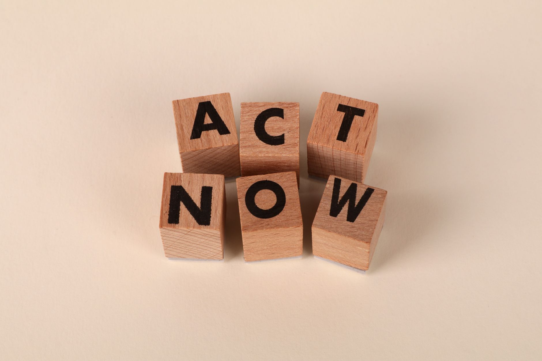 Call-to-Action Best Practices: Buttons, Copy, and Placement 1 Wooden blocks with letters spelling 'ACT NOW', promoting urgency and motivation.
