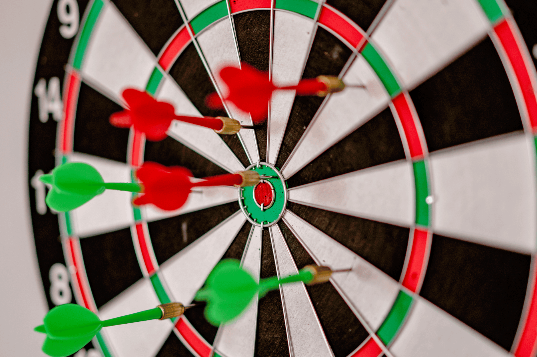 Google Ads Quality Score: Lower CPC Without Cutting Lead Quality 1 Close-up focus on darts hitting the bullseye on a dartboard, symbolizing precision and accuracy.